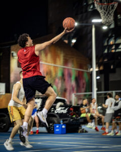 Basketball player attempting a layup during a game