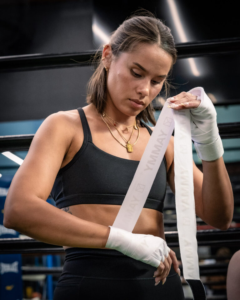 Athlete having hands wrapped before a boxing training session