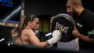 Australian boxer Skye Nicolson throws a punch into focus pads during a live training demonstration at an Everlast event.